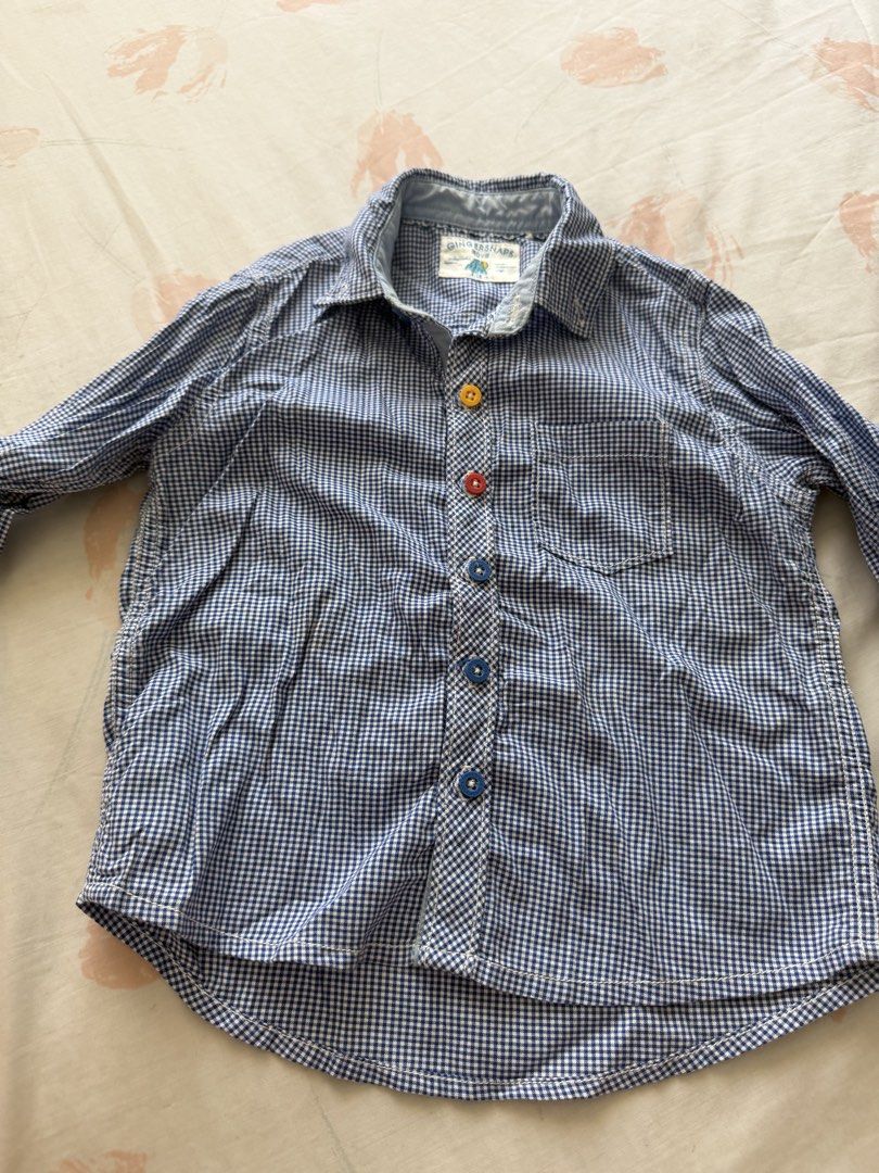 Gingersnaps Boys Blue Gingham Button-Up Shirt Size 4 (Category: Babies & Kids Fashion) located in Manila. Submitted by fitandshop (Listing ID 1461576414, Image 3). Description: - Cute blue gingham button-up shirt - Brand: Gingersnaps - Features colorful buttons on front and cuffs - Material: 100% Cotton - Perfect for casual wear.
