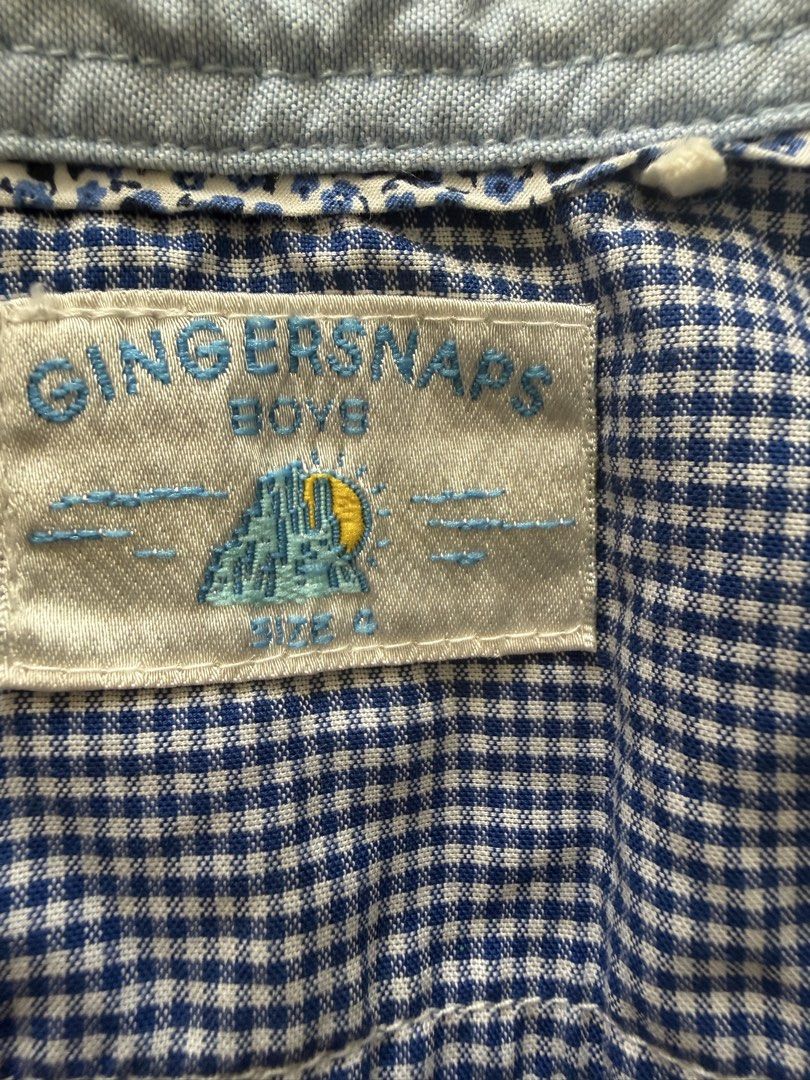 Gingersnaps Boys Blue Gingham Button-Up Shirt Size 4 (Category: Babies & Kids Fashion) located in Manila. Submitted by fitandshop (Listing ID 1461576414, Image 1). Description: - Cute blue gingham button-up shirt - Brand: Gingersnaps - Features colorful buttons on front and cuffs - Material: 100% Cotton - Perfect for casual wear.