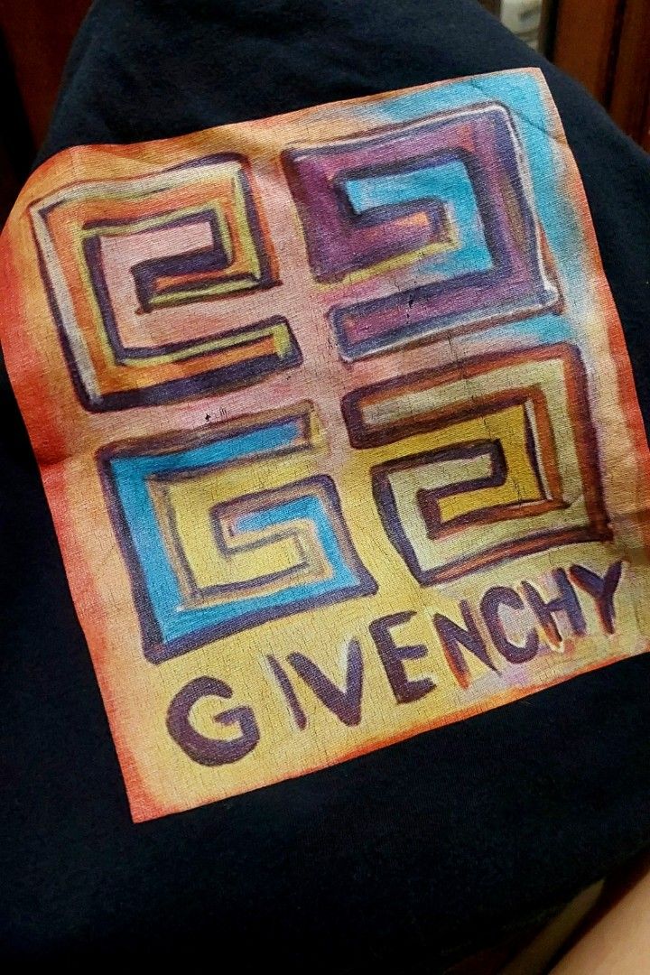 Givenchy Josh Smith Logo Print Black T-Shirt (Category: Babies & Kids Fashion) located in Caloocan City. Submitted by clairyyyyy (Listing ID 1461694702, Image 2). Description: - Authentic Black Givenchy T-shirt - Features unique Josh Smith abstract maze logo print - Colorful design with Givenchy name at the bottom - Ideal for Givenchy enthusiasts and collectors - High-quality fabric and print issue: Crack print pero likenew pa pinaka tela super b