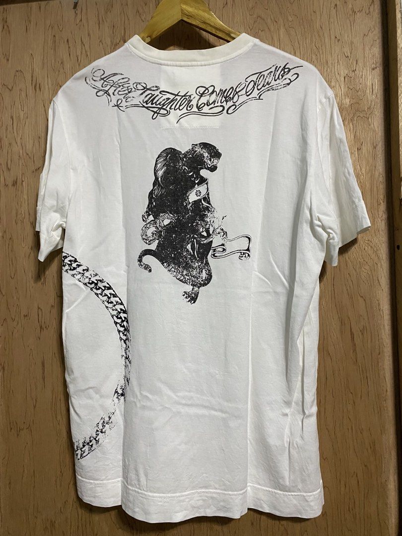 Givenchy White Graphic T-Shirt (Category: Shirts) located in Manila. Submitted by callejage69430 (Listing ID 1461727787, Image 2). Description: 22 width 28 Length - Authentic Givenchy T-shirt - Color: White - Material: 100% Cotton - Size: L - Front Graphic: Compass design - Back Graphic: Panther with text - Perfect for a stylish and casual look.