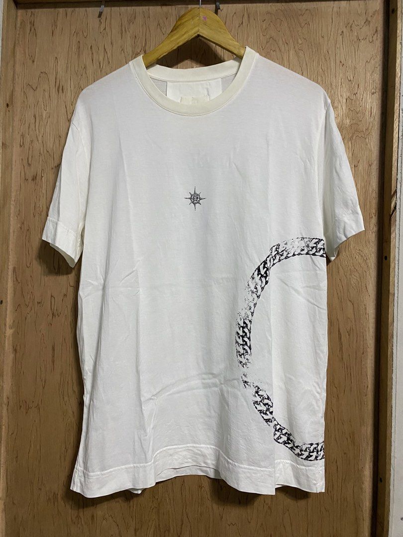 Givenchy White Graphic T-Shirt (Category: Shirts) located in Manila. Submitted by callejage69430 (Listing ID 1461727787, Image 1). Description: 22 width 28 Length - Authentic Givenchy T-shirt - Color: White - Material: 100% Cotton - Size: L - Front Graphic: Compass design - Back Graphic: Panther with text - Perfect for a stylish and casual look.