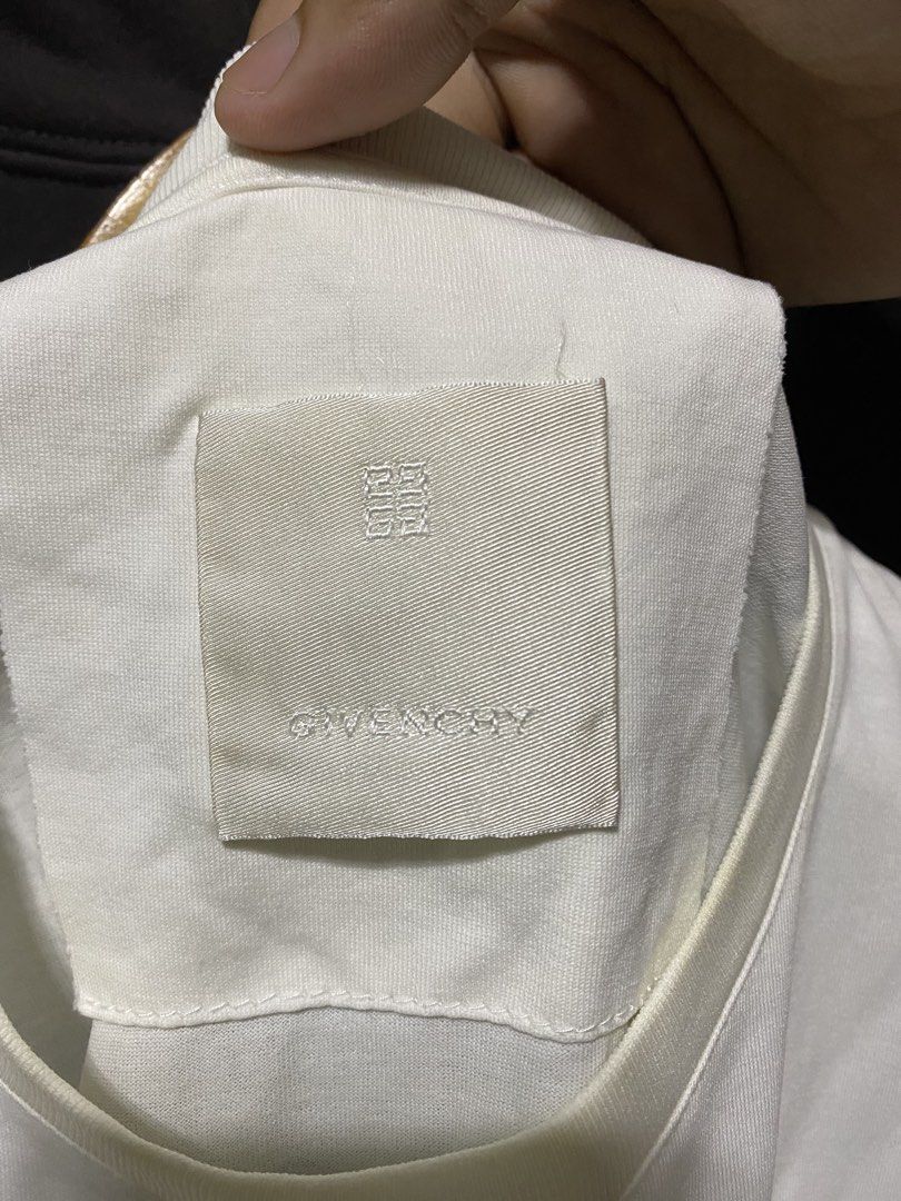 Givenchy White Graphic T-Shirt (Category: Shirts) located in Manila. Submitted by callejage69430 (Listing ID 1461727787, Image 3). Description: 22 width 28 Length - Authentic Givenchy T-shirt - Color: White - Material: 100% Cotton - Size: L - Front Graphic: Compass design - Back Graphic: Panther with text - Perfect for a stylish and casual look.