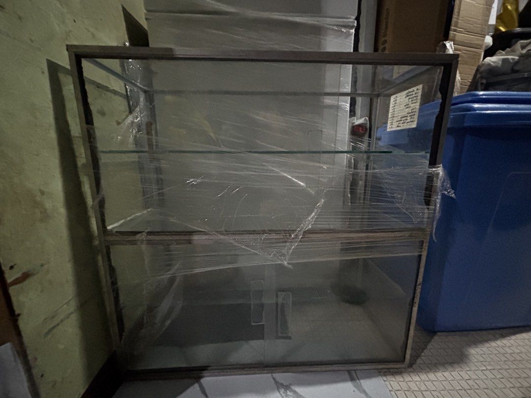 Glass Display Cabinet with Metal Frame (Category: Shelves, Cabinets & Racks) located in Manila. Submitted by aaaeina (Listing ID 1461768916, Image 3). Description: - 24x24 inches & 9” width. - NO ISSUES. Good as new. - Sleek glass display cabinet with a durable metal frame. - Two spacious shelves for ample storage or showcasing your items. - Clear glass panels offer excellent visibility. - Wrapped in cling wrap. PM for more pictures. CUBAO Locati