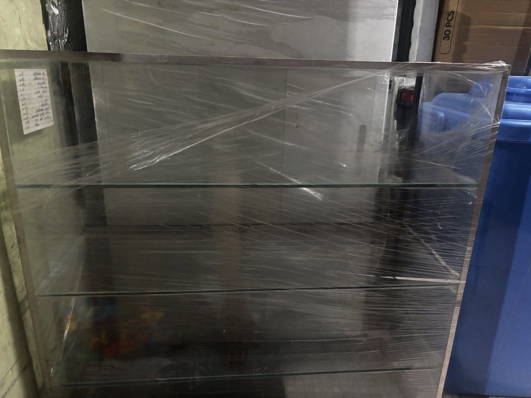 Glass Display Cabinet with Metal Frame (Category: Shelves, Cabinets & Racks) located in Manila. Submitted by aaaeina (Listing ID 1461768916, Image 2). Description: - 24x24 inches & 9” width. - NO ISSUES. Good as new. - Sleek glass display cabinet with a durable metal frame. - Two spacious shelves for ample storage or showcasing your items. - Clear glass panels offer excellent visibility. - Wrapped in cling wrap. PM for more pictures. CUBAO Locati