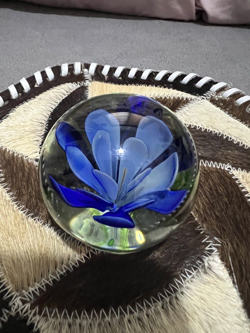 Glass Paperweight with Blue Flower Inside (Category: Vases & Decorative Bowls) located in Las Pinas. Submitted by maple0305 (Listing ID 1461645766, Image 1). Description: - Delicate blue flower encased in clear glass sphere. - Adds a beautiful pop of color to any desk or shelf. - Functional as a paperweight or purely decorative. - Intricate floral design. - A lovely addition to any collection..