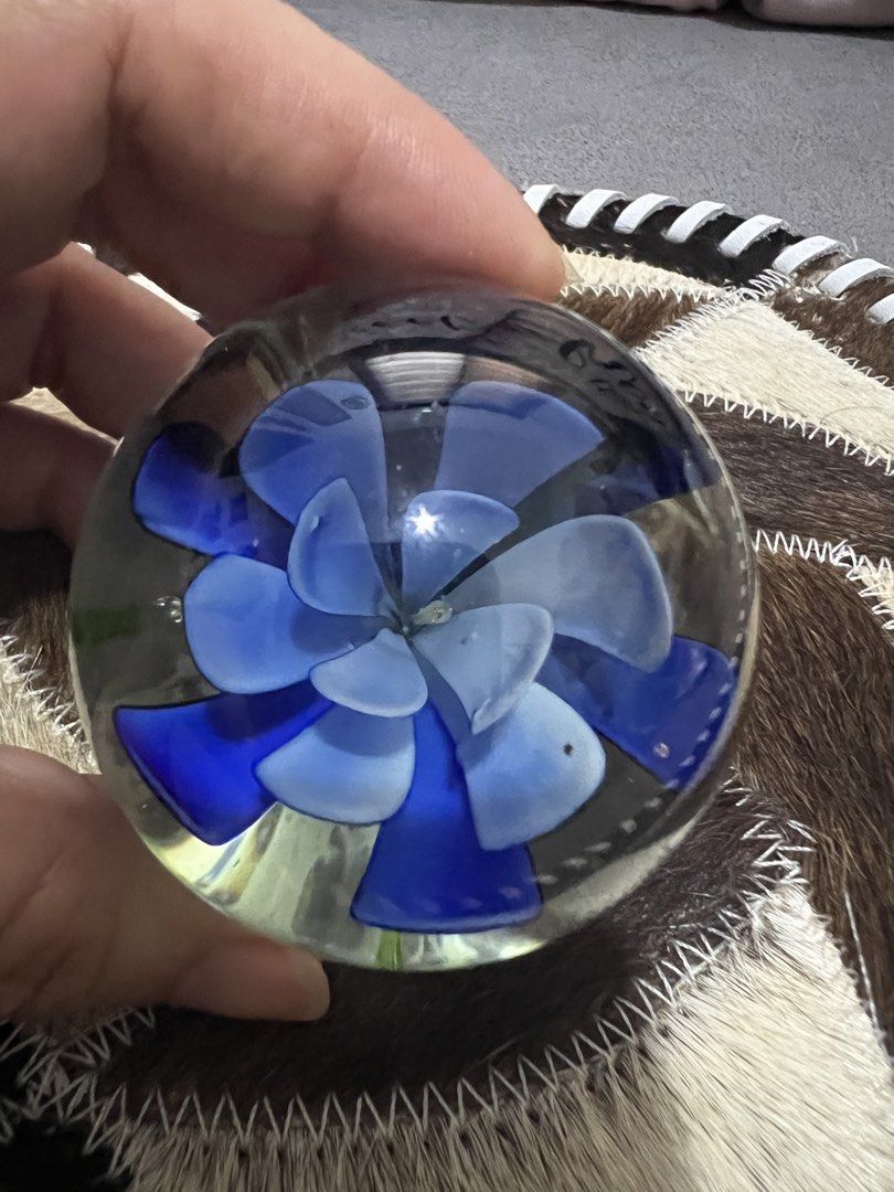 Glass Paperweight with Blue Flower Inside (Category: Vases & Decorative Bowls) located in Las Pinas. Submitted by maple0305 (Listing ID 1461645766, Image 2). Description: - Delicate blue flower encased in clear glass sphere. - Adds a beautiful pop of color to any desk or shelf. - Functional as a paperweight or purely decorative. - Intricate floral design. - A lovely addition to any collection..