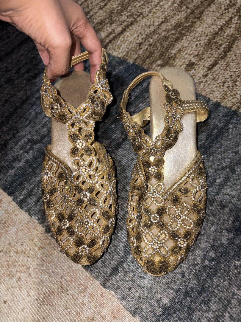 Gold Rhinestone Heels with Strap (Category: Heels) located in Quezon City. Submitted by xennnz (Listing ID 1461585682, Image 3). Description: - Stunning gold heels with intricate bead and rhinestone embellishments. - Elegant t-strap and ankle strap design. - Chic metallic gold heel. - Shows some signs of wear on heel tips and soles. - Perfect for special occasions or to add a touch of glamour to any outfit. - bought this for 380 thriftshop .