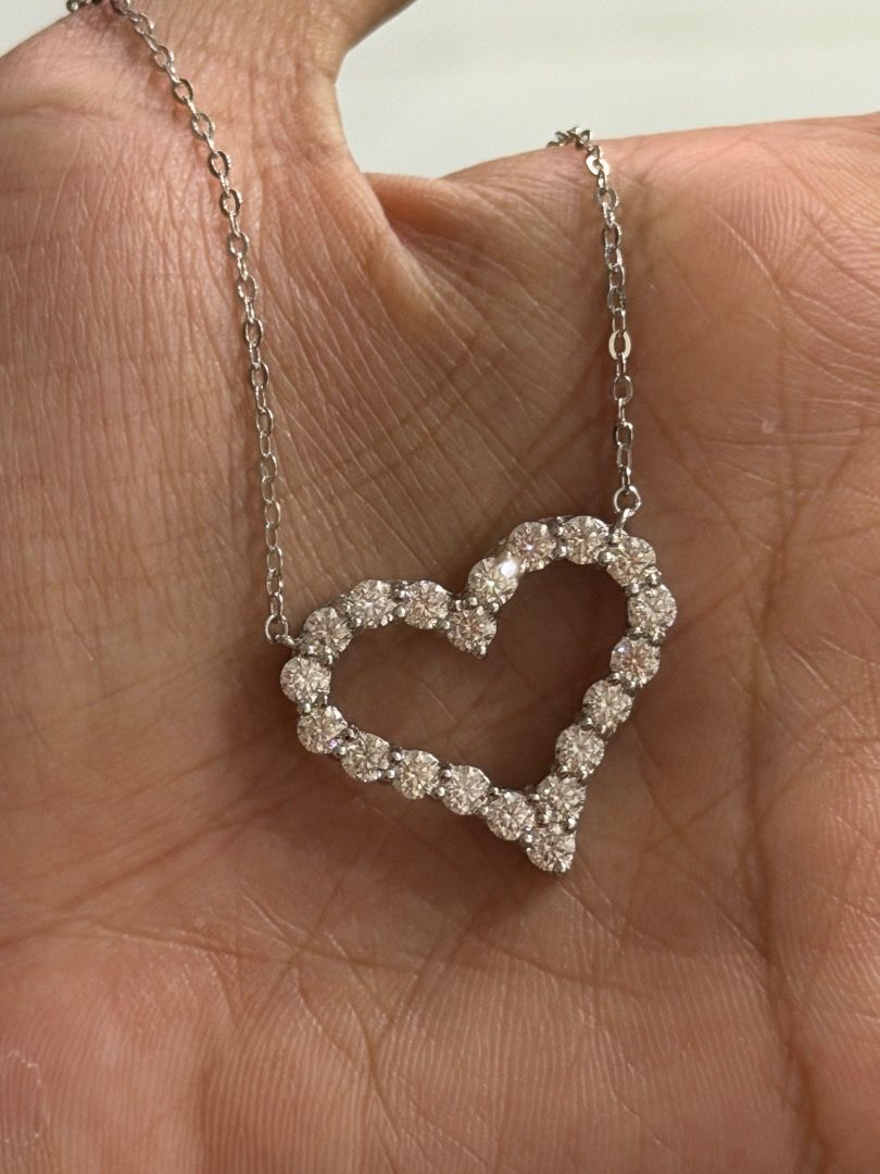 GRA Moissanite OPEN Heart Necklace 2ct (Category: Necklaces) located in Paranaque City. Submitted by marielle01 (Listing ID 1461653096, Image 3). Description: - Elegant heart-shaped pendant necklace - Features brilliant moissanite stones - Comes with GRA report and certificate of authenticity - Silver-toned chain - Total stone weight: 2ct - Stone shape: Round brilliant.