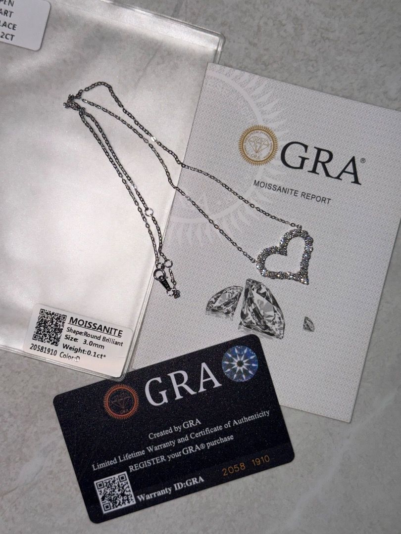 GRA Moissanite OPEN Heart Necklace 2ct (Category: Necklaces) located in Paranaque City. Submitted by marielle01 (Listing ID 1461653096, Image 2). Description: - Elegant heart-shaped pendant necklace - Features brilliant moissanite stones - Comes with GRA report and certificate of authenticity - Silver-toned chain - Total stone weight: 2ct - Stone shape: Round brilliant.