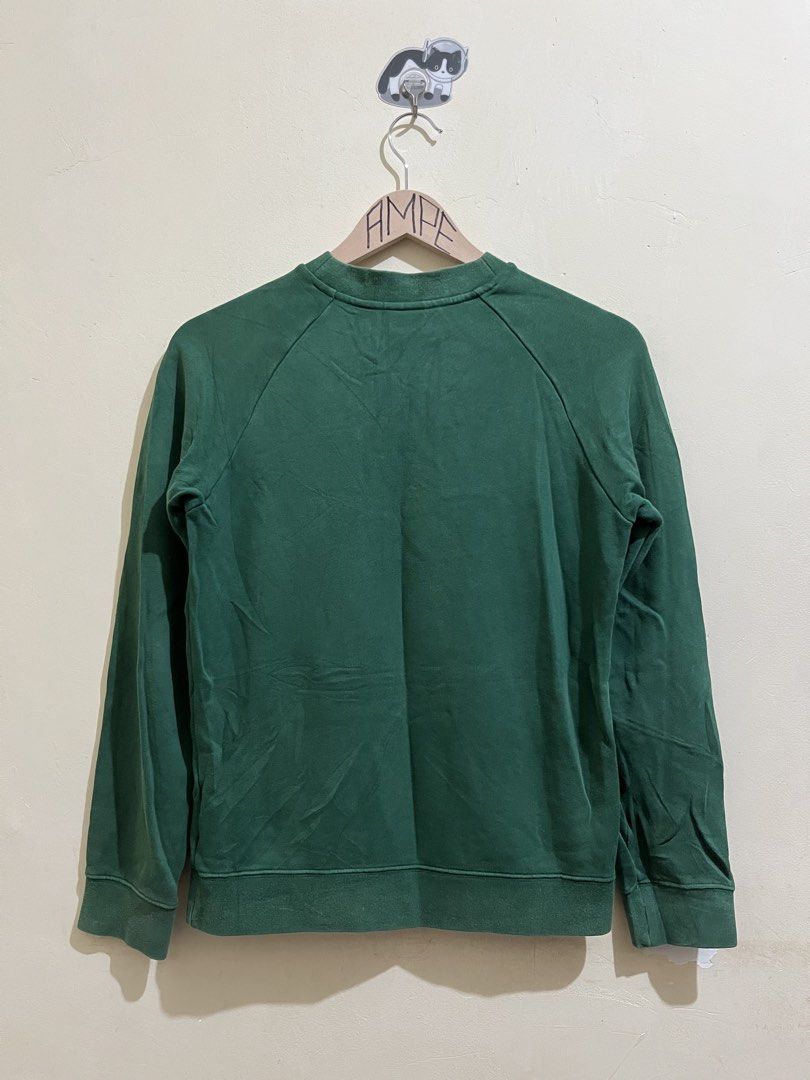 Green Adidas Trefoil Logo Sweatshirt (Category: Coats, Jackets and Outerwear) located in Manila. Submitted by juspheroca82034 (Listing ID 1461685286, Image 2). Description: - Classic green Adidas sweatshirt - Iconic white Trefoil logo on front - Raglan sleeves - Ribbed cuffs and hem - Perfect for casual wear - Shows some signs of wear, particularly on the logo.