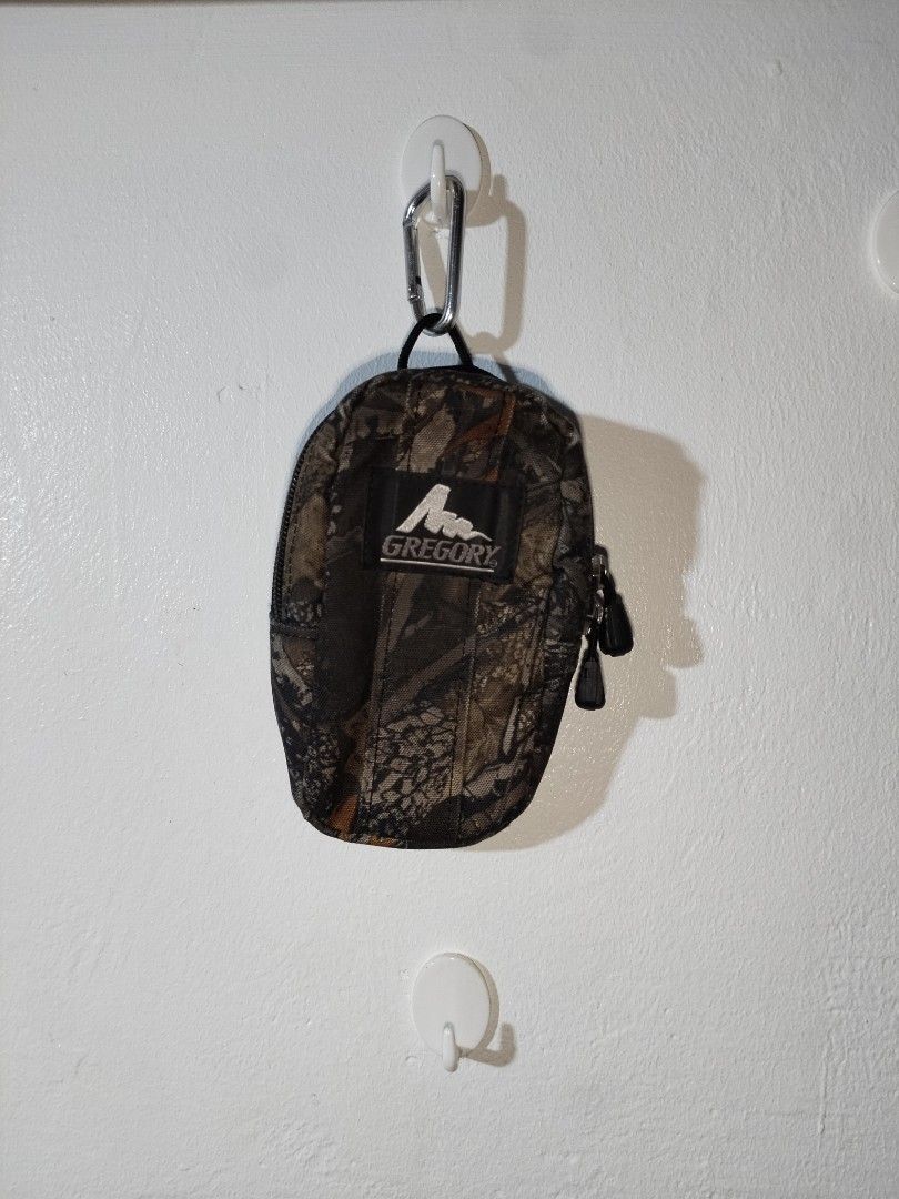 Gregory Camo Pouch with Carabiner Clip (Category: Belt bags, Clutches and Pouches) located in Pasig City. Submitted by loveforlux_2025 (Listing ID 1461590364, Image 1). Description: - Gregory Pouch in stylish camouflage pattern. - Features a spacious main zippered compartment. - Includes a convenient smaller front pocket. - Comes with a carabiner clip for easy attachment. - Ideal for organizing small essentials. - Made with durable material. - Gr