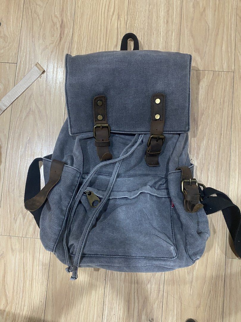 Grey Canvas Backpack (Category: Backpacks) located in Rizal. Submitted by protractor (Listing ID 1461709273, Image 1). Description: ISSUES: SIDE POCKET HAS NO BUCKLE Location: Taytay, Rizal MOP: GCASH SF: Shoulder by Buyer Del: Via Lalamove/ J&T .