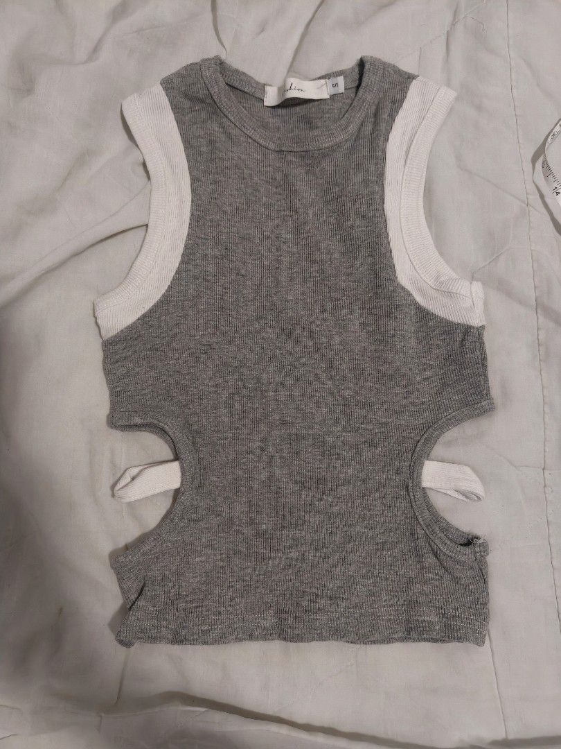 Grey Ribbed Cutout Crop Top with White Trim (Category: Sleeveless) located in Antipolo. Submitted by _suspiria (Listing ID 1461669139, Image 1). Description: - Small on tag best fits XS-S - Grey ribbed crop top - White trim on shoulders - Side cutouts.