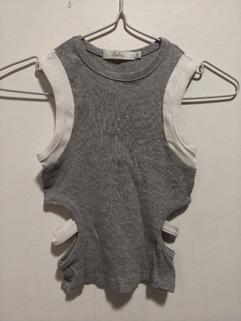 Grey Ribbed Cutout Crop Top with White Trim (Category: Sleeveless) located in Antipolo. Submitted by _suspiria (Listing ID 1461669139, Image 2). Description: - Small on tag best fits XS-S - Grey ribbed crop top - White trim on shoulders - Side cutouts.