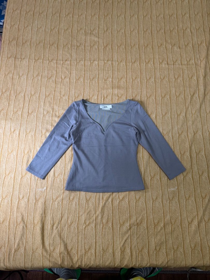 Grey V-neck Long Sleeve Top (Category: Longsleeves) located in Calasiao. Submitted by clothesbykim (Listing ID 1461694445, Image 1). Description: - Grey long-sleeved top - V-neckline - Soft and stretchy fabric - Fitted silhouette - Great for layering or wearing on its own - Simple and versatile wardrobe staple.