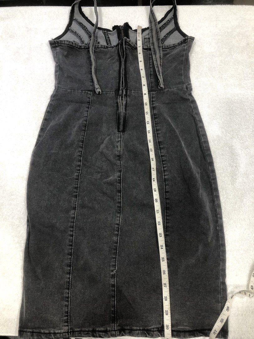Grey Wash Denim Dress with Front Slit (Category: Dresses) located in Manila. Submitted by janmichael26601 (Listing ID 1461608828, Image 2). Description: - Grey wash denim dress - Front zipper closure - Thigh-high slit for a stylish look - Adjustable straps for a perfect fit - Made in China - Measurements: Waist - 14 inches, Length - 30 inches.