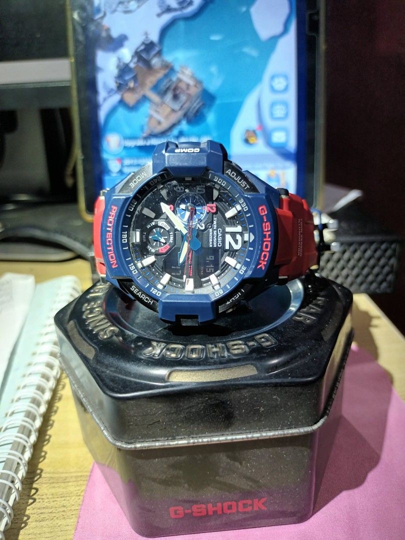 G-Shock GA-1100 Twin Sensor Watch (Category: Men's Watches) located in Manila. Submitted by markdelfin1979 (Listing ID 1461789495, Image 1). Description: - G-Shock GA-1100 Watch - Striking Blue and Red Colorway - Twin Sensor (Temperature & Direction) - World Time Functionality - Alarm Feature - 20 Bar Water Resistance (200m) - Authentic, Made in Thailand - Includes Original G-Shock Tin - Ideal for Everyday Wear and Outdoor Activities.
