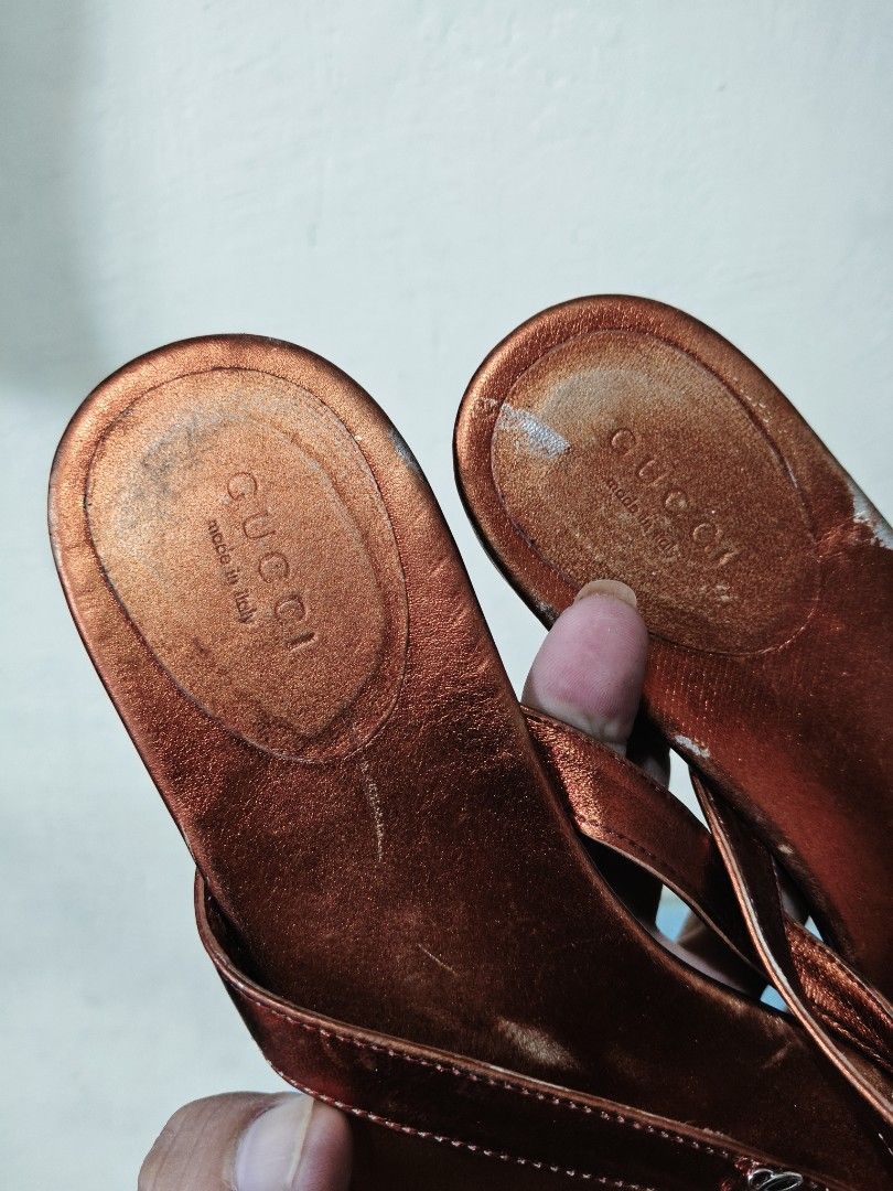 Gucci (Category: Slippers and slides) located in Mandaue City. Submitted by prekfinds (Listing ID 1461722596, Image 3). Description: Gucci Flip flop sandal Metallic Orange Leather Embossed Script Logo on tha strap Verygood condition Sign of usage.