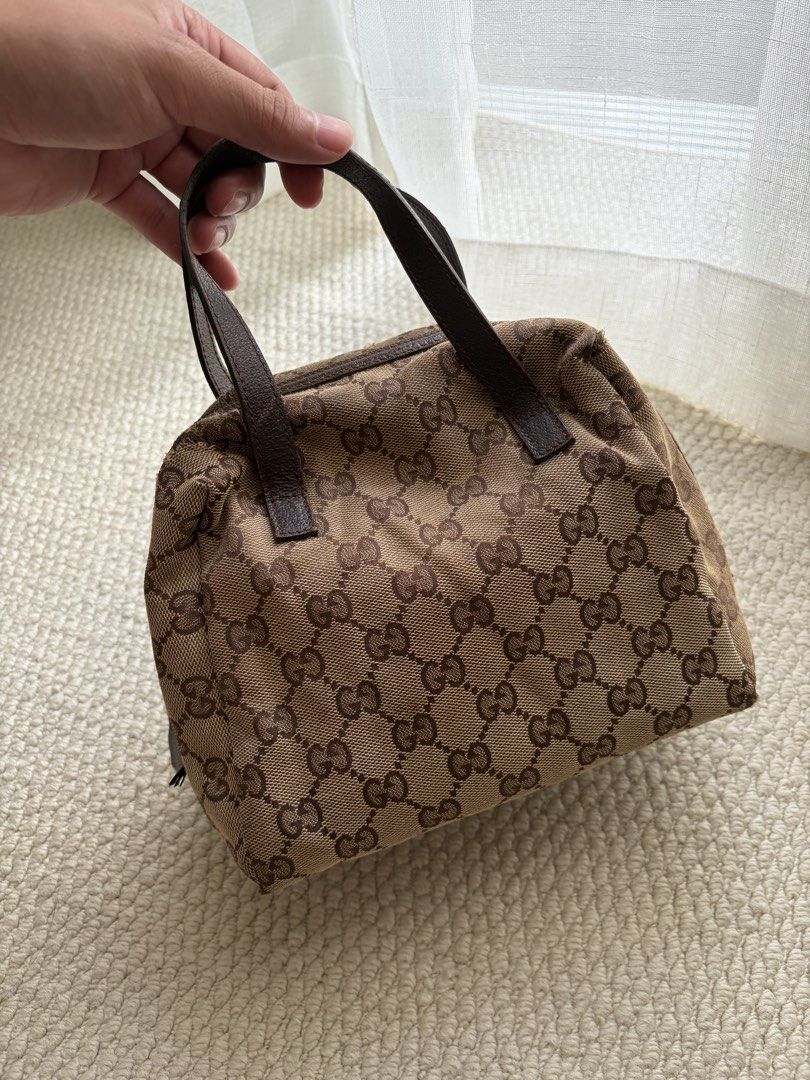 Gucci Authentic (Category: Luxury Bags & Wallets) located in Pasig City. Submitted by flamecloset (Listing ID 1461667940, Image 1). Description: Gucci Tofu Authentic Mini hand bag - Classic GG Monogram Canvas (Brown) - Genuine Leather Trim - Interior Green Lining - Serial number visible inside.