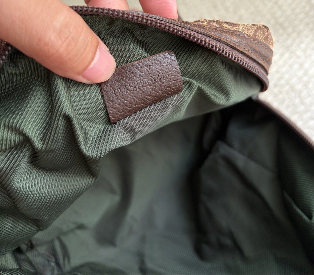 Gucci Authentic (Category: Luxury Bags & Wallets) located in Pasig City. Submitted by flamecloset (Listing ID 1461667940, Image 3). Description: Gucci Tofu Authentic Mini hand bag - Classic GG Monogram Canvas (Brown) - Genuine Leather Trim - Interior Green Lining - Serial number visible inside.