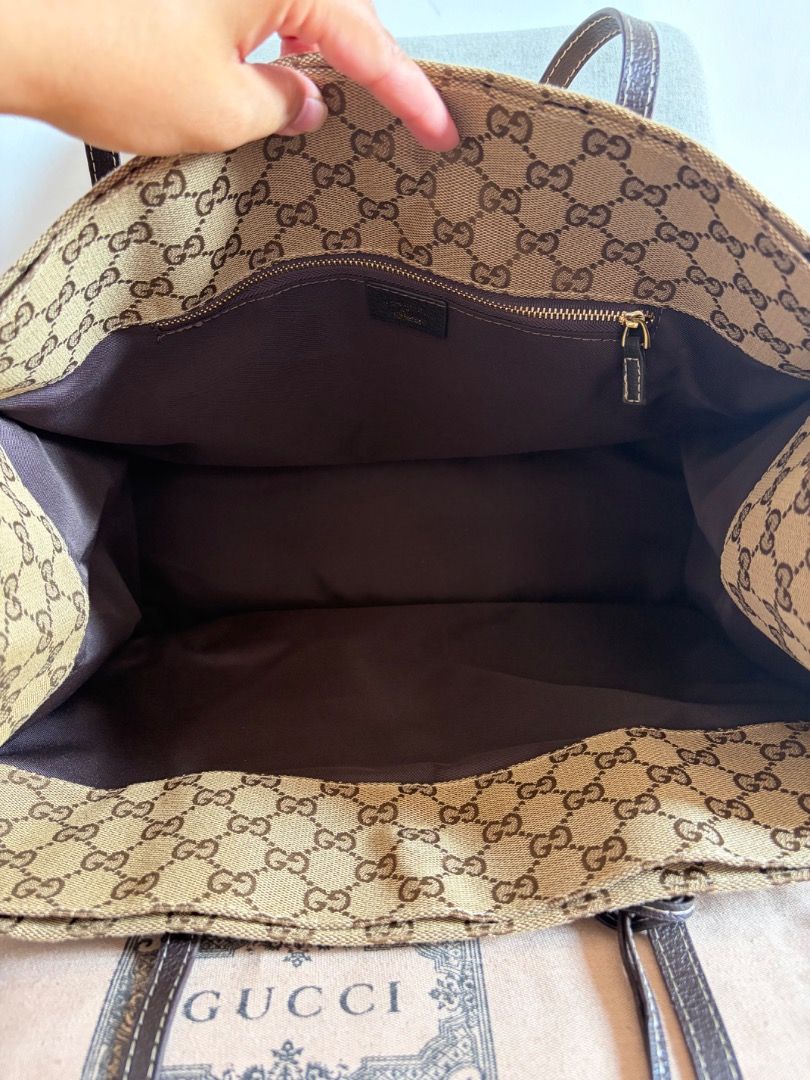Gucci GG Monogram Canvas Tote Bag (Category: Luxury Bags & Wallets) located in Quezon City. Submitted by missclutterfree (Listing ID 1461705864, Image 3). Description: - Gucci tote bag - Classic GG monogram canvas with leather trim - Spacious interior with a zip pocket - Perfect for everyday use or travel - Comes with dust bag - large capacity tote bag - like new, no issues .