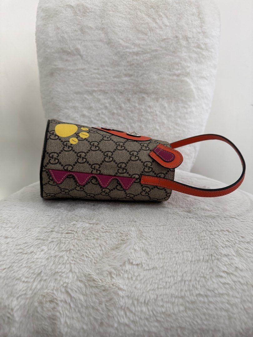 Gucci GG Supreme Monogram bucket bag (Category: Luxury Bags & Wallets) located in Quezon City. Submitted by closet24 (Listing ID 1461653863, Image 3). Description: Monogram coated canvas with children’s design. Orange leather strap. Orange Nylon Interior. Signs of use on lining of one ear *see photo Inclusions : gucci dustbag.