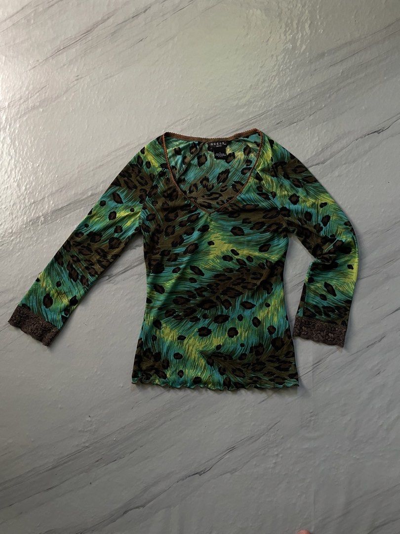 Guess Jeans Leopard Print Long Sleeve Mesh Top Size S (Category: Longsleeves) located in Midsayap. Submitted by archieaquino24 (Listing ID 1461624134, Image 2). Description: - Guess Jeans long sleeve top - Size: S - Print: Green, blue, and brown leopard and abstract pattern - Details: Lace trim on neckline and cuffs - Material: 100% Nylon - Style: Casual, edgy.