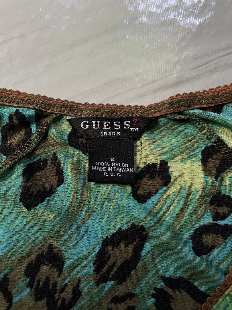 Guess Jeans Leopard Print Long Sleeve Mesh Top Size S (Category: Longsleeves) located in Midsayap. Submitted by archieaquino24 (Listing ID 1461624134, Image 3). Description: - Guess Jeans long sleeve top - Size: S - Print: Green, blue, and brown leopard and abstract pattern - Details: Lace trim on neckline and cuffs - Material: 100% Nylon - Style: Casual, edgy.
