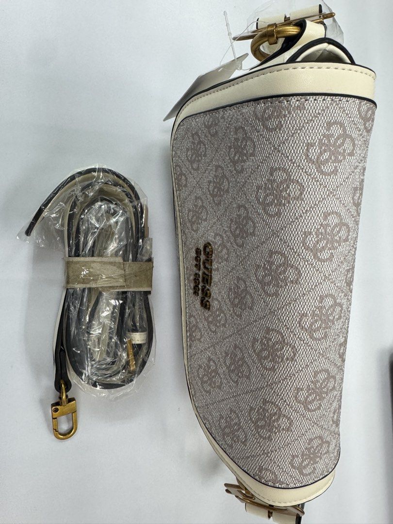Guess Monogram Shoulder Bag with Extra Strap (Category: Shoulder Bags) located in Makati City. Submitted by jusua (Listing ID 1461577782, Image 3). Description: - Guess shoulder bag in signature monogram print - Cream trim and gold hardware - Comes with a detachable and adjustable crossbody strap - Secure flap closure - Versatile for everyday use or evening outings.