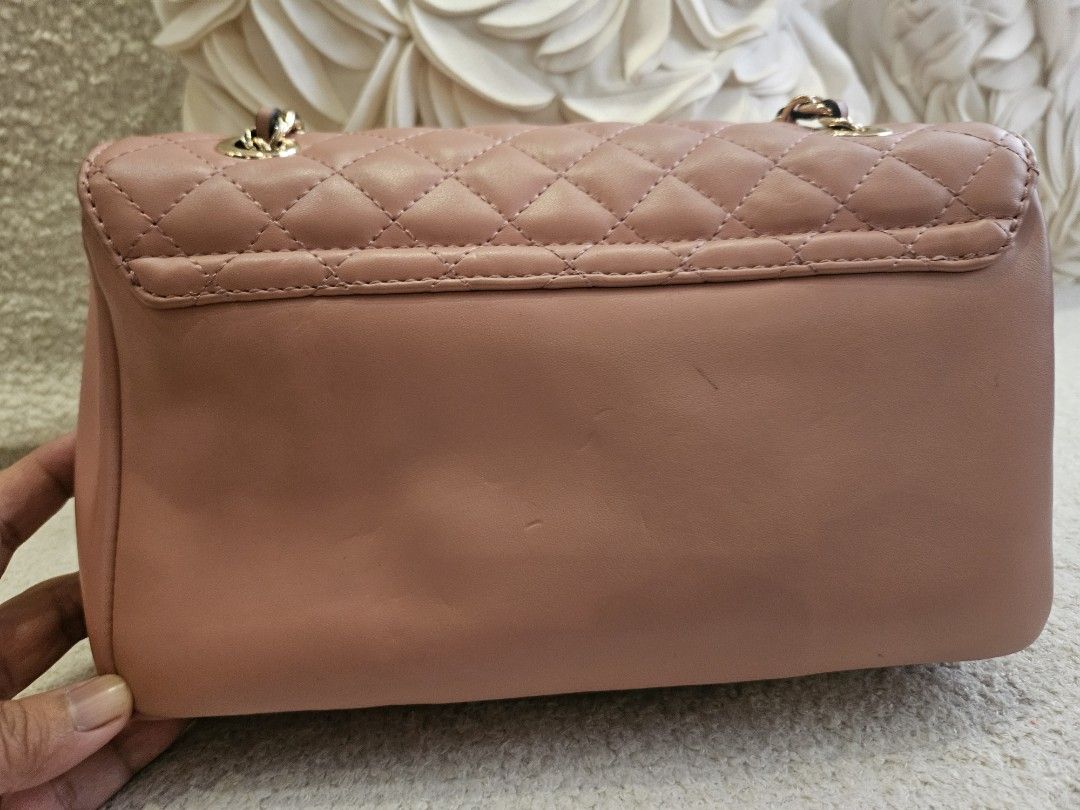 Guess Quilted Chain Shoulder Bag Dusty Rose (Category: Shoulder Bags) located in Pasig City. Submitted by momshiem (Listing ID 1461594779, Image 3). Description: - Dusty rose quilted shoulder bag by Guess - Elegant gold chain strap - Secure turn-lock closure with 'Los Angeles' engraving - Interior zip and slip pockets for organization - Versatile for nights out or everyday wear - with chain marks due to storage Sf - c/o buyer.