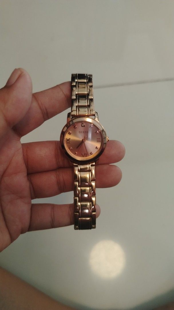 Guess Rose Gold Watch (Category: Women's Watches) located in Manila. Submitted by wildwind_73f77a (Listing ID 1461568827, Image 1). Description: - Elegant rose gold Guess watch - Features Roman numeral hour markers - Accented with small diamond markers - Durable stainless steel band - Water resistant for everyday wear - Secure clasp with embossed Guess logo - Versatile for both casual and formal outfits.