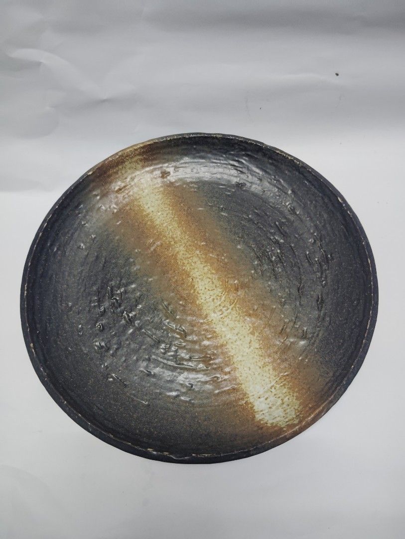 Handmade Ceramic Serving Plate Rustic Earth Tones (Category: Dinnerware & Cutlery) located in Manila. Submitted by epicrabbit-968a (Listing ID 1461748635, Image 1). Description: - Rustic ceramic plate - Unique earth-toned glaze - Textured surface for character - Approx. 10-inch diameter - Versatile: great for serving or as a decorative piece -japanese earthen wares -sale @150 each, orig price @300-500.