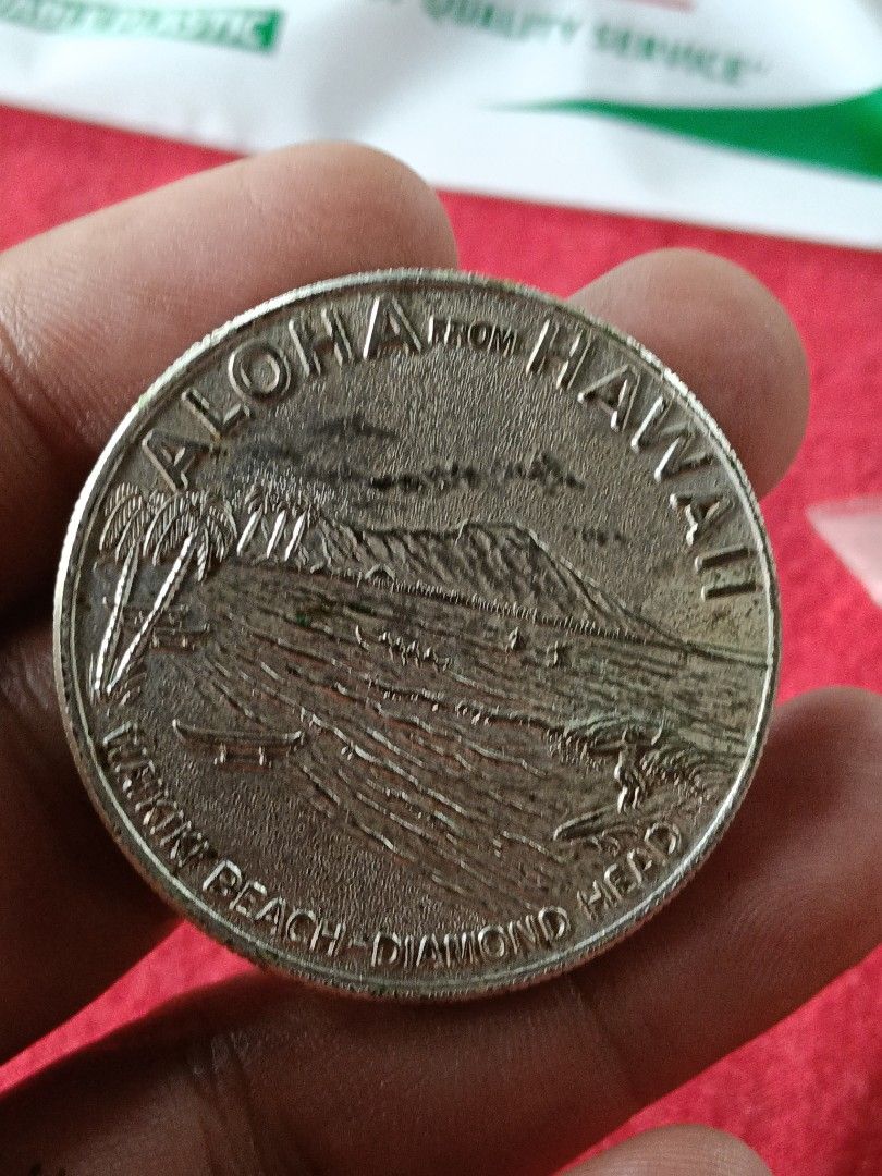 Hawaii Dollar Honolulu Souvenir Coin (Category: Currency) located in Batangas. Submitted by swiftstone.96924b (Listing ID 1461622796, Image 2). Description: - Commemorative coin from Honolulu, Hawaii - Features King Kamehameha on one side - Depicts Waikiki Beach with Diamond Head on the other - Ideal for coin collectors or as a travel keepsake - Shows some signs of age, but remains a nice piece.