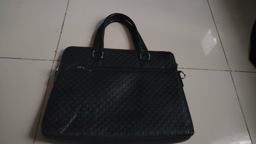 Hayesaroo Black Textured Briefcase (Category: Briefcases) located in Manila. Submitted by wildwind_73f77a (Listing ID 1461587119, Image 3). Description: - Sleek black briefcase with a sophisticated textured pattern. - Main compartment with secure zipper closure. - Internal pockets for organized storage. - Comfortable dual top handles for easy carrying. - Ample space, perfect for work documents or travel necessities..