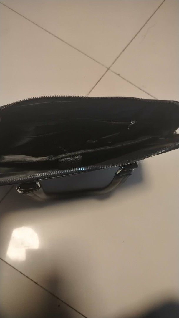 Hayesaroo Black Textured Briefcase (Category: Briefcases) located in Manila. Submitted by wildwind_73f77a (Listing ID 1461587119, Image 2). Description: - Sleek black briefcase with a sophisticated textured pattern. - Main compartment with secure zipper closure. - Internal pockets for organized storage. - Comfortable dual top handles for easy carrying. - Ample space, perfect for work documents or travel necessities..