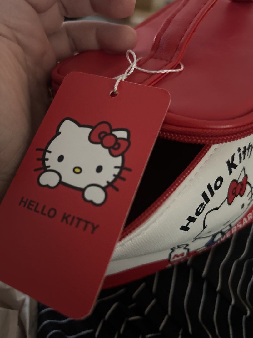 Hello Kitty 45th Anniversary Cosmetic Bag (Category: Makeup) located in Quezon City. Submitted by asiaco (Listing ID 1461620120, Image 3). Description: Cute Kitty 45th Anniversary cosmetic bag. White and red with Kitty graphics. Red interior with Kitty pattern. Features cute Kitty zipper charms. Perfect for makeup or travel..