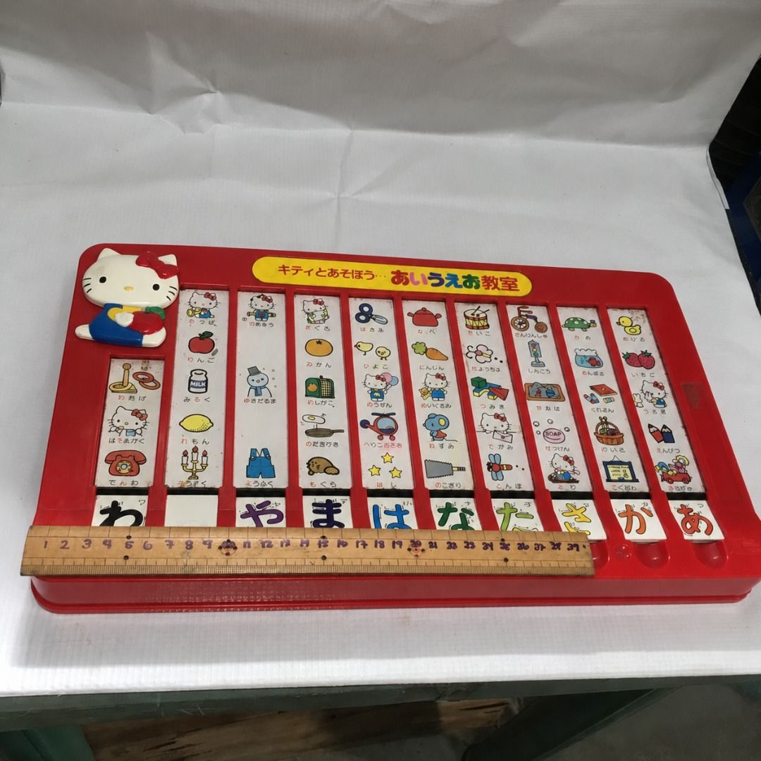 Hello Kitty AIUEO Hiragana study Toy #4983 (Category: Educational & Learning Toys) located in Malabon City. Submitted by mldg.surplus (Listing ID 1461638969, Image 2). Description: - Vintage Kitty toy for learning Japanese hiragana. - Features a red plastic base with movable tiles. - A fun and unique educational tool for introducing Japanese writing. - Great for collectors or as a nostalgic gift..