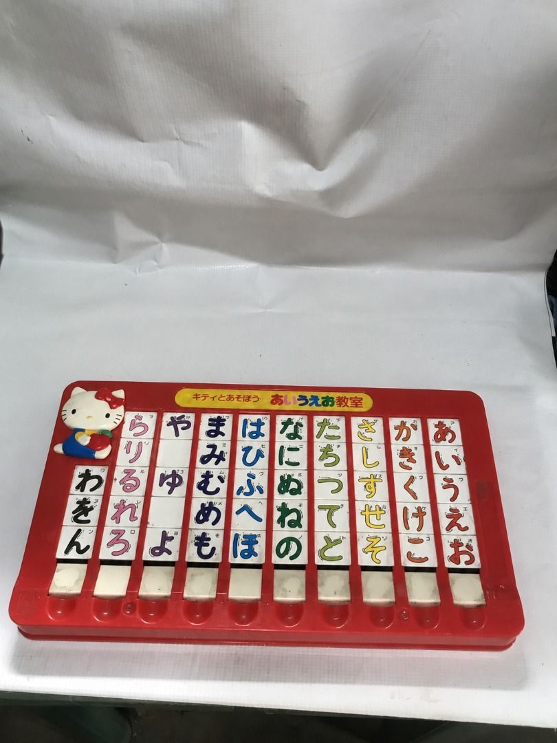 Hello Kitty AIUEO Hiragana study Toy #4983 (Category: Educational & Learning Toys) located in Malabon City. Submitted by mldg.surplus (Listing ID 1461638969, Image 1). Description: - Vintage Kitty toy for learning Japanese hiragana. - Features a red plastic base with movable tiles. - A fun and unique educational tool for introducing Japanese writing. - Great for collectors or as a nostalgic gift..