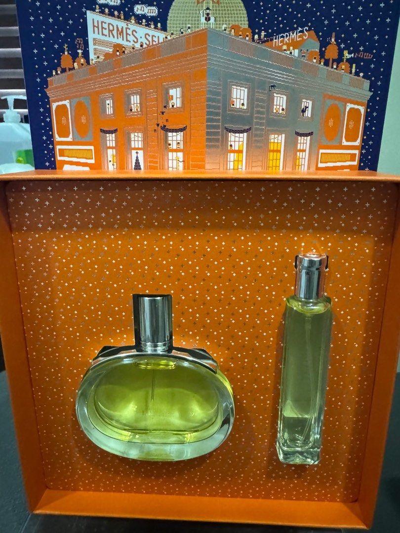 Hermes Eau de Toilette Perfume Set (Category: Fragrance & Deodorants) located in Caloocan City. Submitted by xenasales (Listing ID 1461668414, Image 1). Description: - Authentic Hermes perfume set - Includes a large oval bottle and a smaller rectangular bottle - Both bottles are full - Features festive building-themed packaging - Ideal for gifting or personal collection.