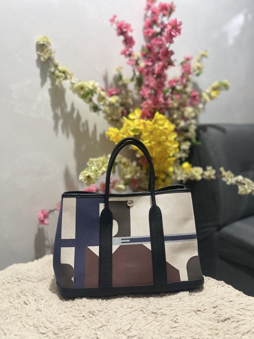 Hermes Garden Party (Category: Luxury Bags & Wallets) located in Manila. Submitted by princesska15212 (Listing ID 1461728390, Image 1). Description: - Stylish geometric print tote bag - Accented with black leather trim and handles - Secure snap closure - Interior zippered pocket for essentials - Clean inside and out - Perfect for daily errands or your next getaway.