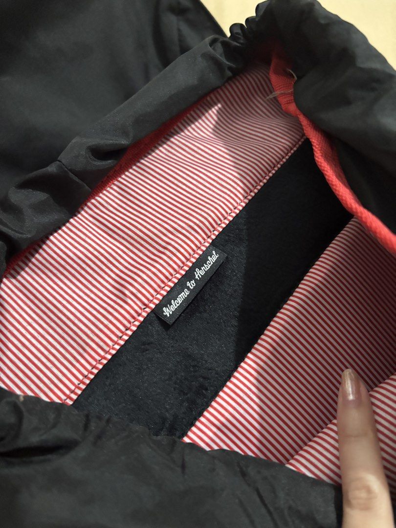 Herschel Little America Backpack Black (Category: Backpacks) located in Lucban. Submitted by quinsdollhouse (Listing ID 1461665766, Image 3). Description: - Classic black Herschel backpack - Brown faux leather straps with buckle closures - Signature red and white striped interior lining - Spacious main compartment for essentials - Adjustable padded shoulder straps for comfort - Just needs cleaning - Ideal for school, work, or everyday carry.