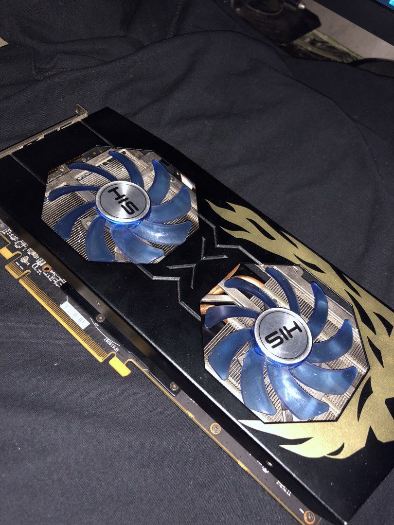 HIS Graphics Card Dual Fan (Category: Other Accessories) located in Manila. Submitted by thirteenk (Listing ID 1461578393, Image 1). Description: - HIS Graphics Card - Dual blue cooling fans - Visible heatsink for efficient cooling - Black shroud with striking gold flame accents - Gold connector pins - Ideal for gaming and demanding PC tasks.