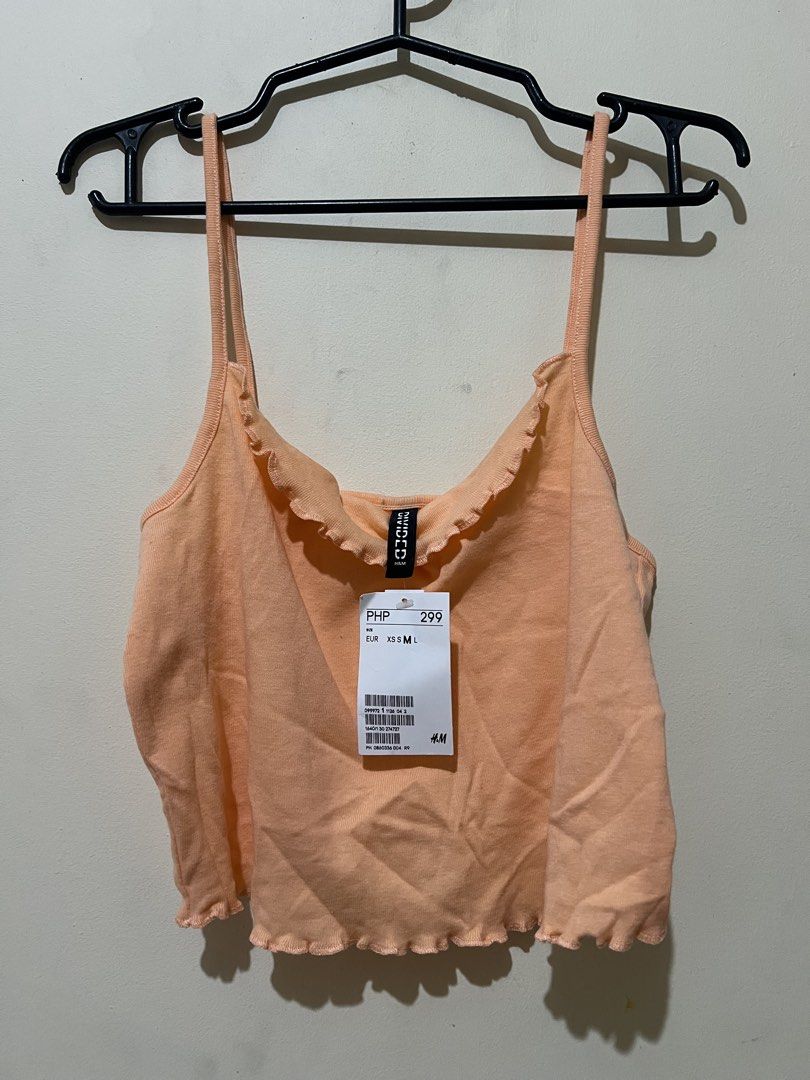 H&M Orange Lettuce Hem Crop Top (Category: Shirts) located in Marikina City. Submitted by kzells13 (Listing ID 1461579880, Image 1). Description: - Brand: H&M - Color: Orange - Style: Crop top - Details: Lettuce hem on neckline and hem, spaghetti straps - Condition: Brand new with tag, never worn - Occasion: Casual wear, layering.