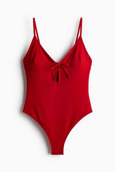 H&M Red Twisted Sexy Bodysuit (Category: Sleeveless) located in Binan City. Submitted by mypreloved_haul (Listing ID 1461693090, Image 3). Description: The item in the image is an H&M red tie-front cutout one-piece bodysuit/swimsuit. It features a V-neck plunge neckline, thin adjustable spaghetti straps, a functional or decorative front tie knot, and a small teardrop keyhole cutout at the chest..