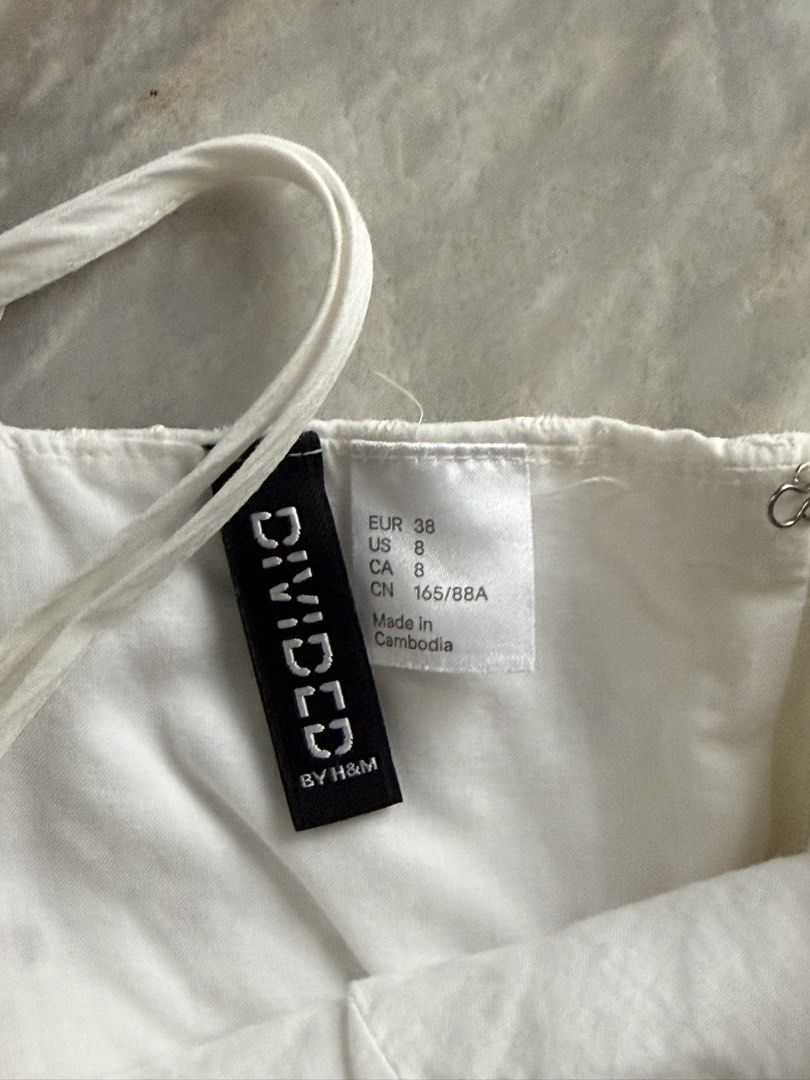 H&M White Eyelet Cotton Sundress (Category: Dresses) located in San Mateo. Submitted by aifoslvdr (Listing ID 1461623559, Image 2). Description: - Brand: H&M - Color: White - Style: Sundress - Features: Eyelet detailing on bodice, adjustable spaghetti straps, elasticated waist - Material: Lightweight cotton - Occasion: Casual wear, beach days.