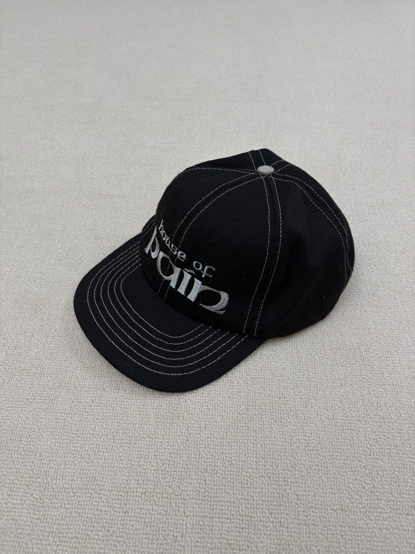 House Of Pain Hat (Category: Caps & Hats) located in Manila. Submitted by porma.market (Listing ID 1461578320, Image 3). Description: - Classic black baseball cap - Embroidered 'House of Pain' logo on the front - White stitching details for a clean look - Unique light blue shamrock design inside - Adjustable strap for a customized fit - Ideal for casual wear and everyday outfits - Gems💎 -90s hat.