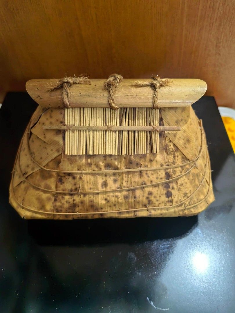 House-shaped Native Container (Category: Other Home Decor) located in Cebu City. Submitted by dudes_villanueva (Listing ID 1461660041, Image 2). Description: House-shaped Native Container or Trinket Box 📌 Crafted from bamboo sheath (také-kawa in Japanese craft styles or similar tropical plant fiber/bamboo leaf crafts), featuring a layered thatched-style roof. 📌 Specks are natural. Not an issue. See all pics for condition. L7.25xW5xH4.5 in.