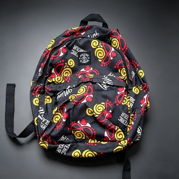 Hysteric Glamour Mini Backpack - All Over Print (Category: Backpacks) located in Baguio. Submitted by miishaysh67446 (Listing ID 1461665721, Image 1). Description: - Brand: Hysteric Glamour - Style: Mini Backpack - Color: Black base - Design: All-over print of sunglasses and swirls - Compartments: Main compartment and front pocket - Straps: Adjustable for comfort - Use: Ideal for everyday wear or as a statement accessory.