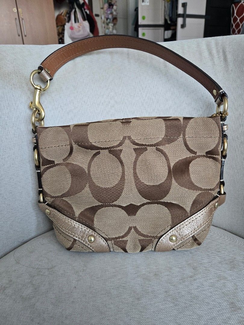 INCH!!! Coach Carly Small Monogram (Category: Luxury Bags & Wallets) located in Manila. Submitted by shla.dln (Listing ID 1461603077, Image 1). Description: - Classic Coach shoulder bag - Signature monogram canvas in tan and brown - Metallic gold leather trim - Gold hardware details - Secure zipper closure - Stylish and practical for everyday use.