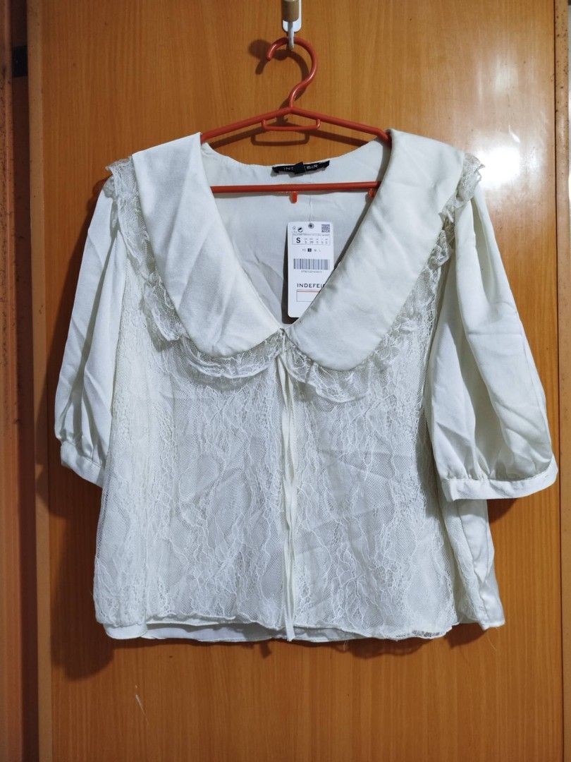 INDEFIR White Lace Peter Pan Collar Blouse Size S (Category: Blouses) located in Quezon City. Submitted by niceoutfits (Listing ID 1461599989, Image 3). Description: - Brand new white blouse with tags attached ( old stock need washing ) - Delicate lace overlay - Charming large Peter Pan collar - Adjustable neck ties - Puffy sleeves with buttoned cuffs - Versatile for cute, vintage-inspired outfits.